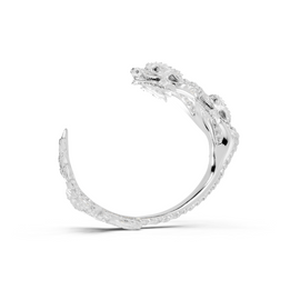 Silver ring with intricate design on a white background