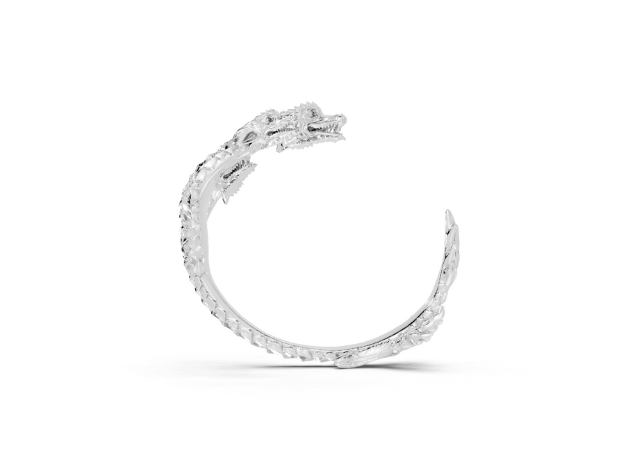 Silver ring with a textured design on a white background