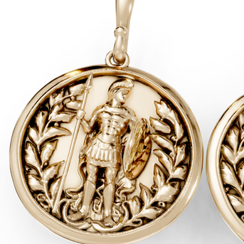 Gold earrings with intricate designs on a white background