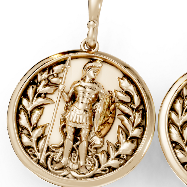 Gold earrings with intricate designs on a white background