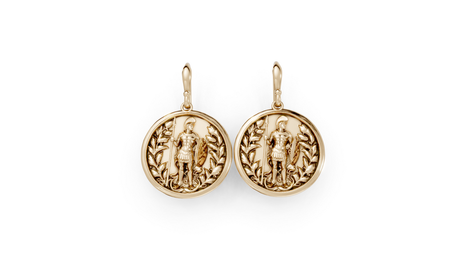 Gold earrings with detailed designs on a white background