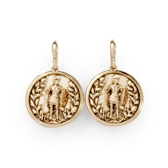 Gold earrings with detailed designs on a white background