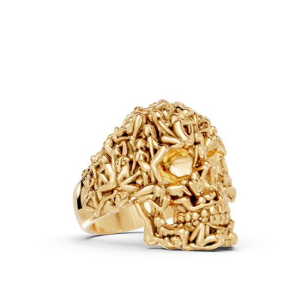 Gold skull-shaped ring on a white background
