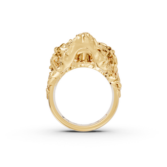 Gold ring with intricate design on a white background