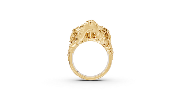 Gold ring with intricate design on a white background