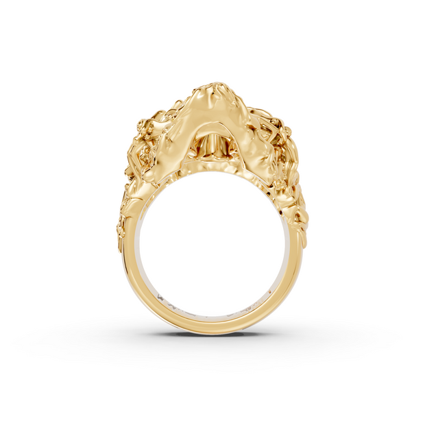 Gold ring with intricate design on a white background
