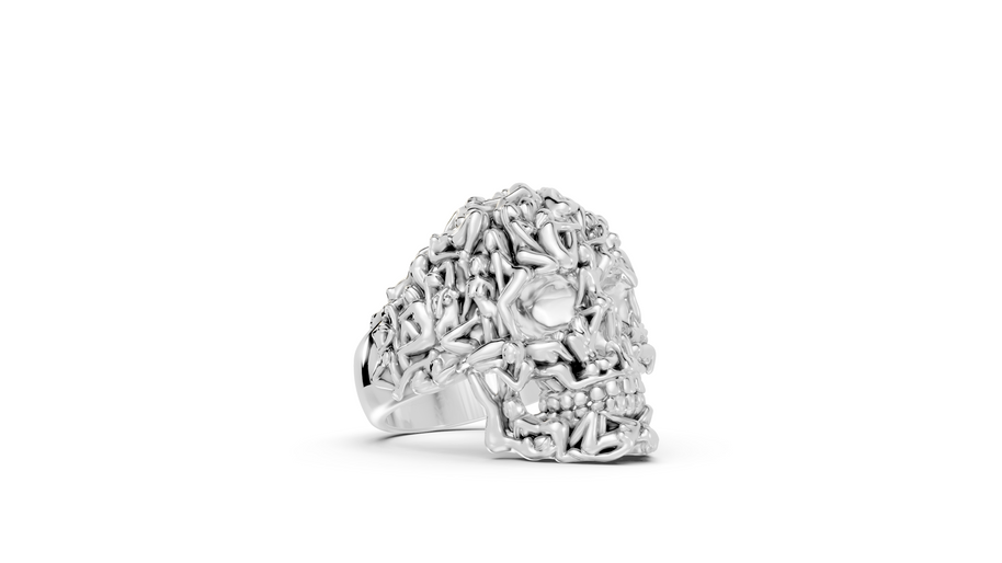 Silver ring with intricate design on a white background