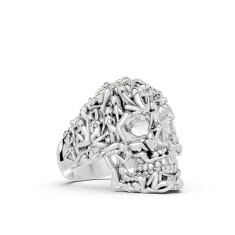 Silver ring with intricate design on a white background