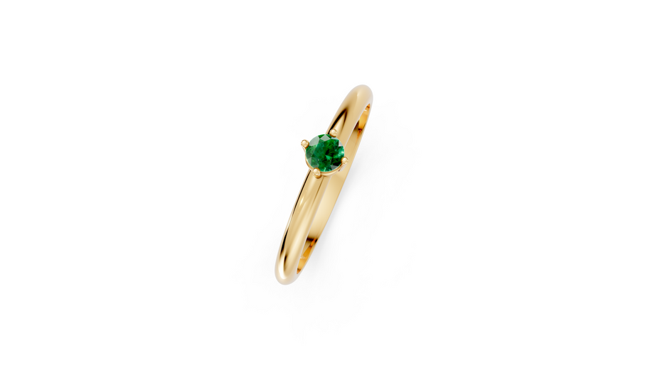 Gold ring with a green gemstone on a white background