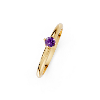 Gold ring with a purple gemstone on a white background