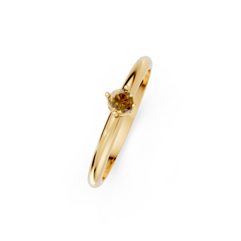 Gold ring with a small gemstone on a white background