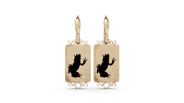 Gold earrings with black frog designs on a white background