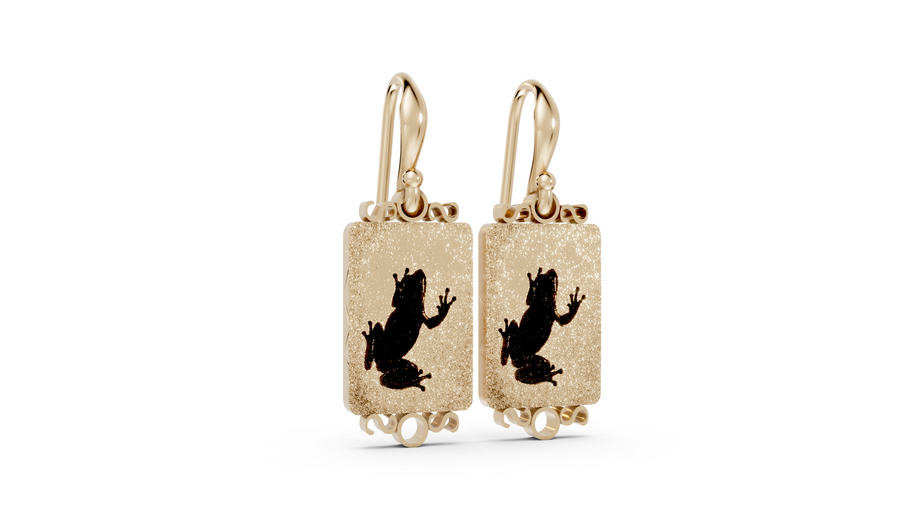 Gold earrings with black silhouette design on a white background