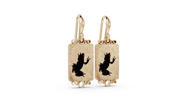 Gold earrings with black silhouette design on a white background
