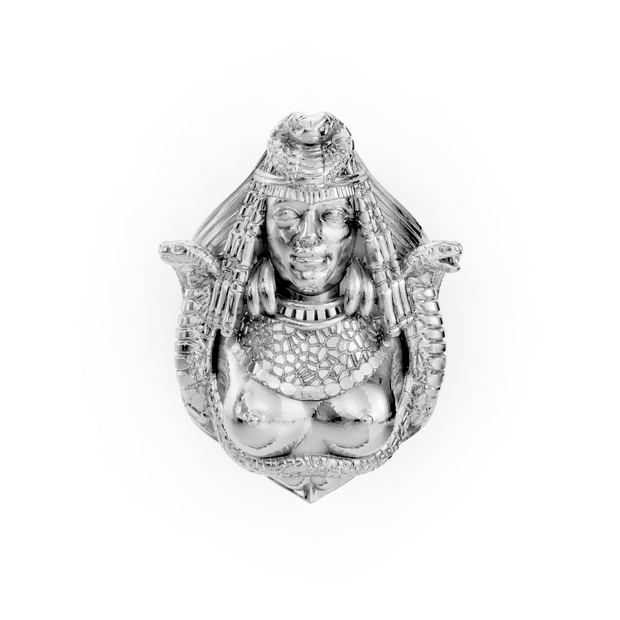 Decorative silver figurine of a seated figure with intricate detailing on a white background