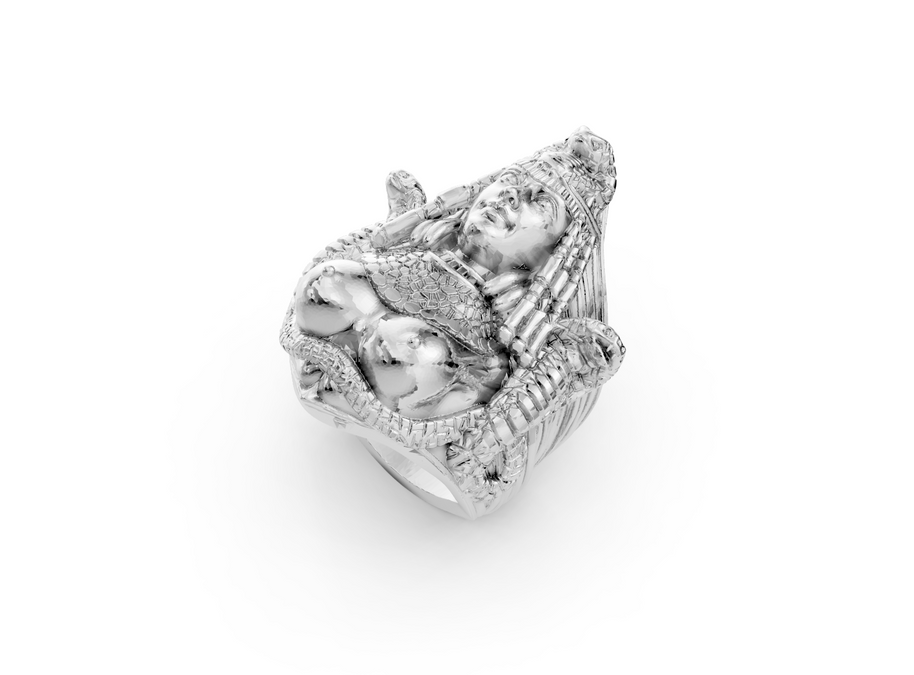 Silver ring with intricate design on a white background