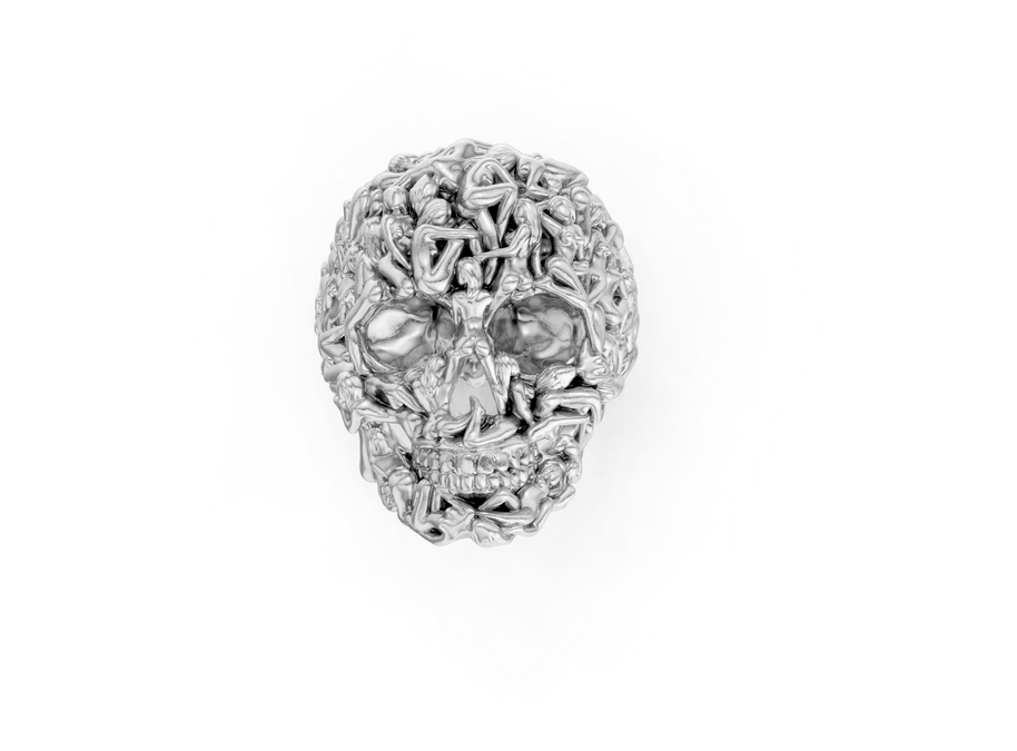 Silver skull-shaped pendant with intricate designs on a white background