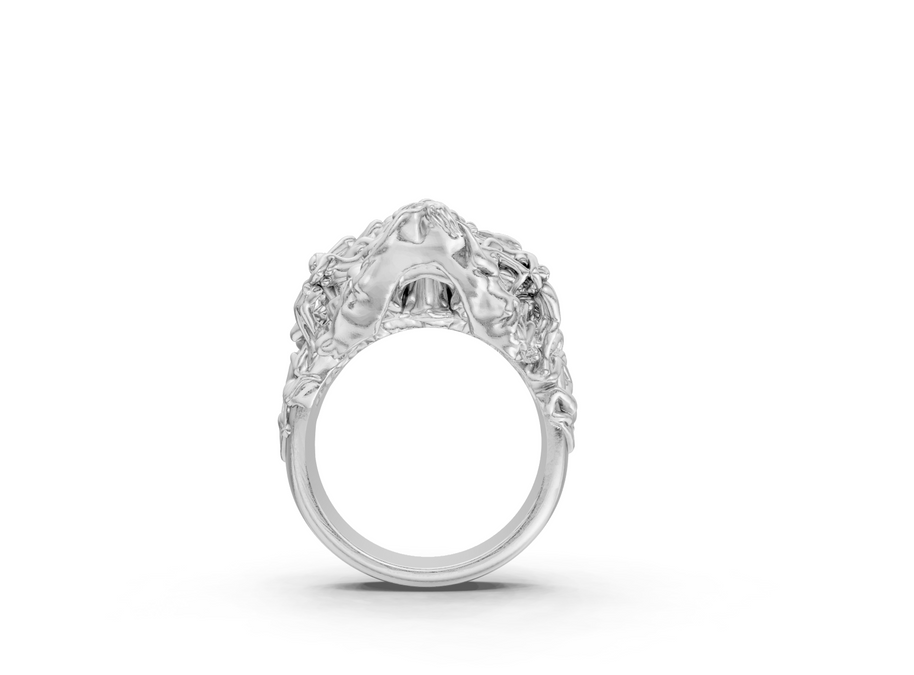 Silver ring with intricate design on a white background