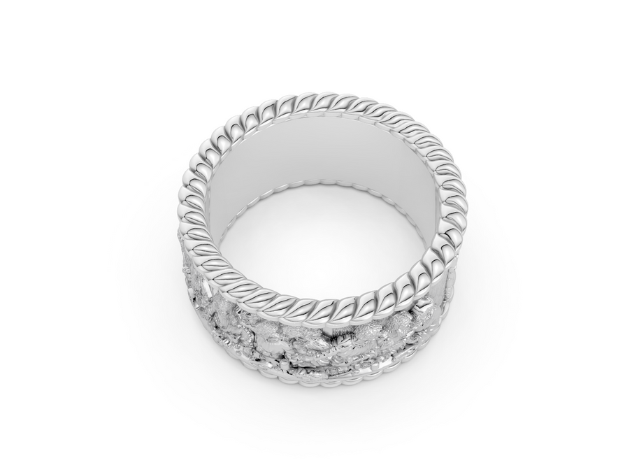 Silver ring with intricate design on a white background