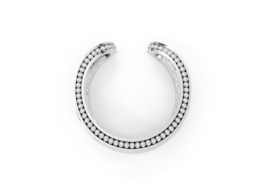 Silver hoop earring with embedded stones on a white background