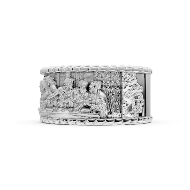 Silver ring with intricate design on a white background