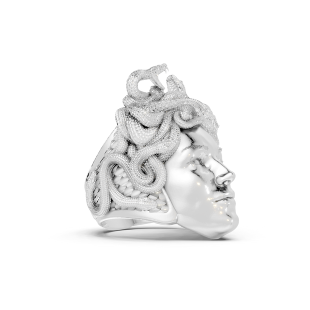 Silver ring with intricate design on a white background