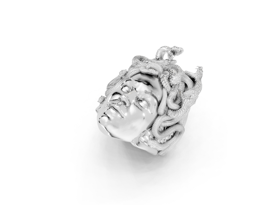Silver pendant with intricate design on a white background