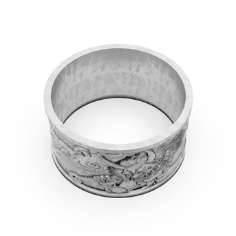 Silver ring with intricate design on a white background