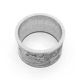 Silver ring with a textured band on a white background